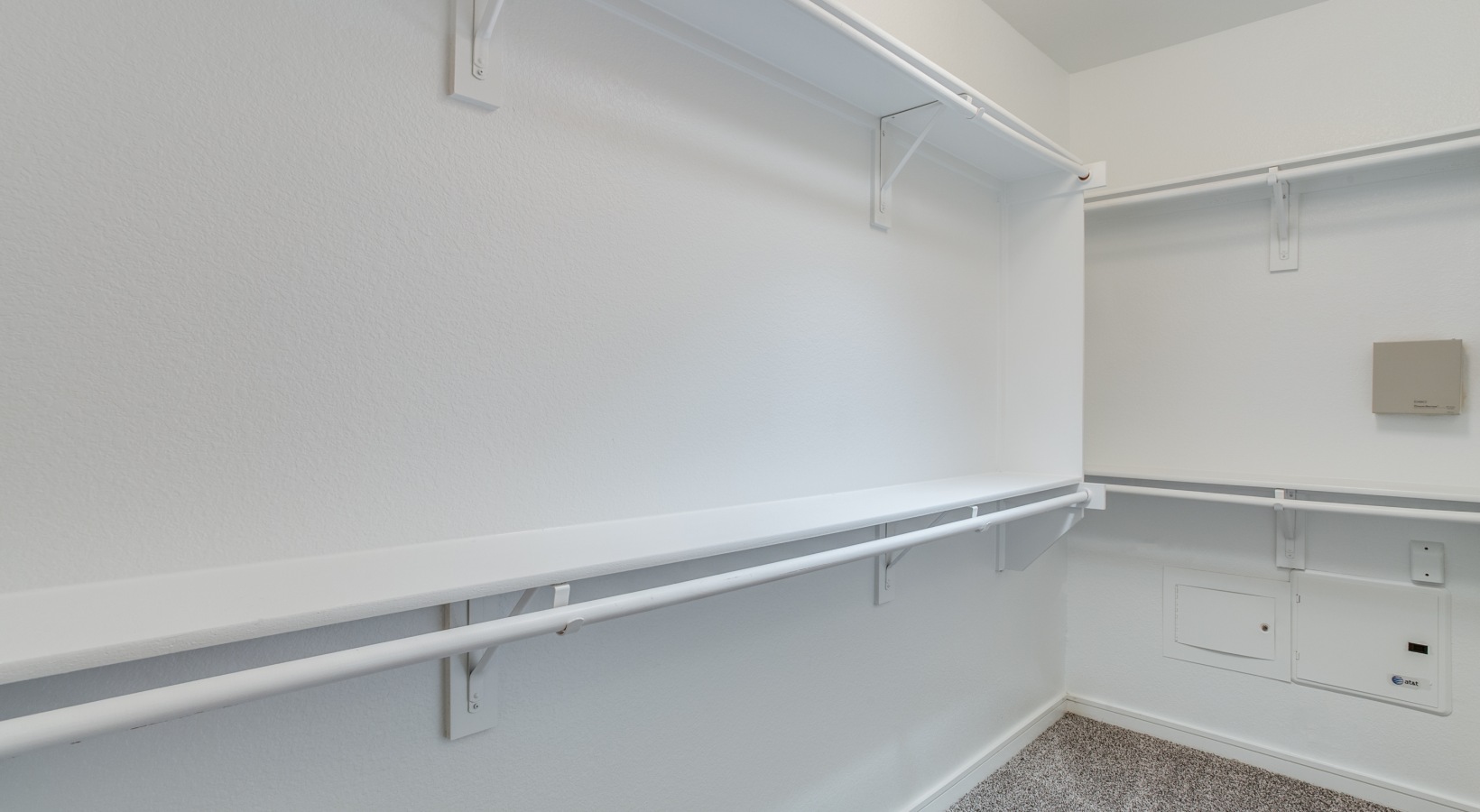 a closet with shelves and white walls at The  Franklin at Samuels Ave