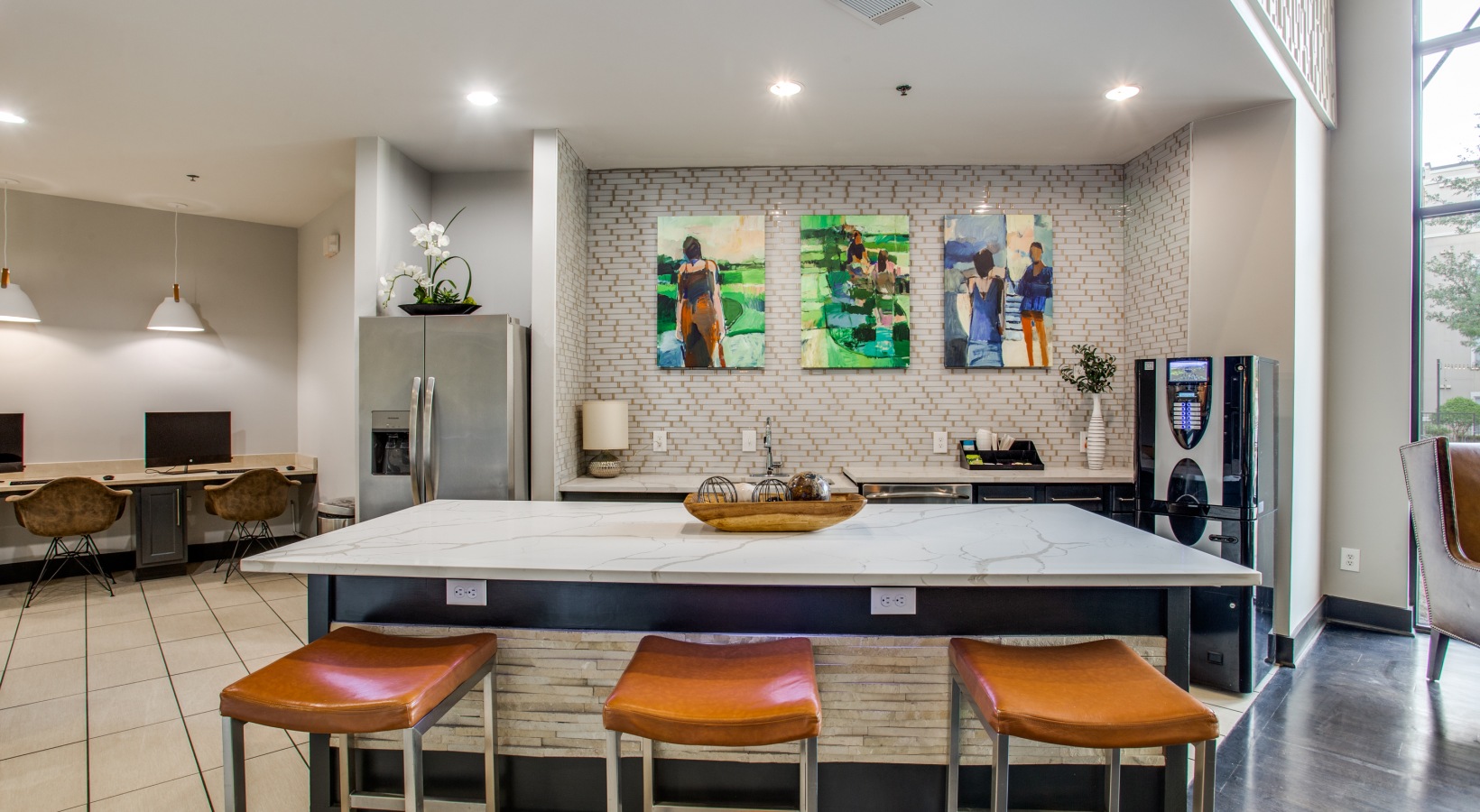 a kitchen with a large island and bar stools at The  Franklin at Samuels Ave