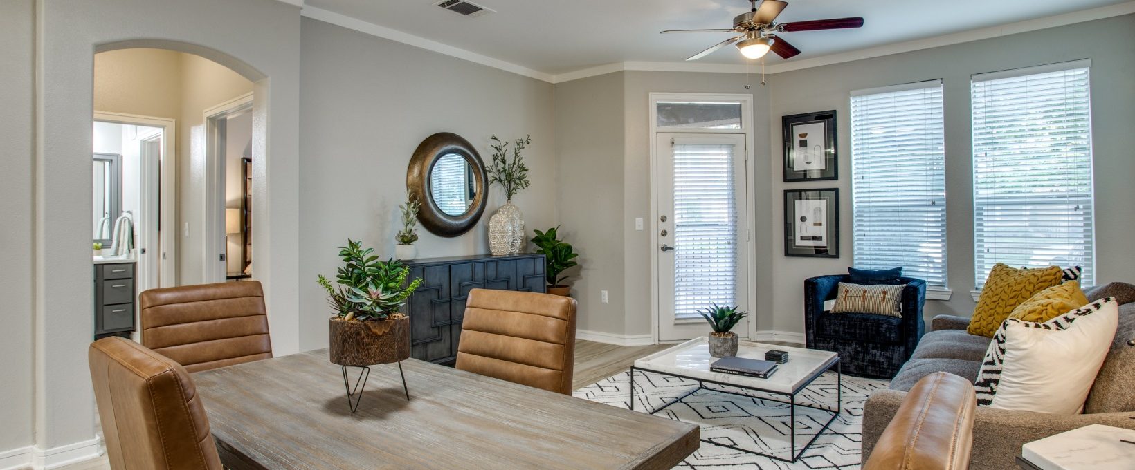 a living room with a dining table and chairs at The  Franklin at Samuels Ave