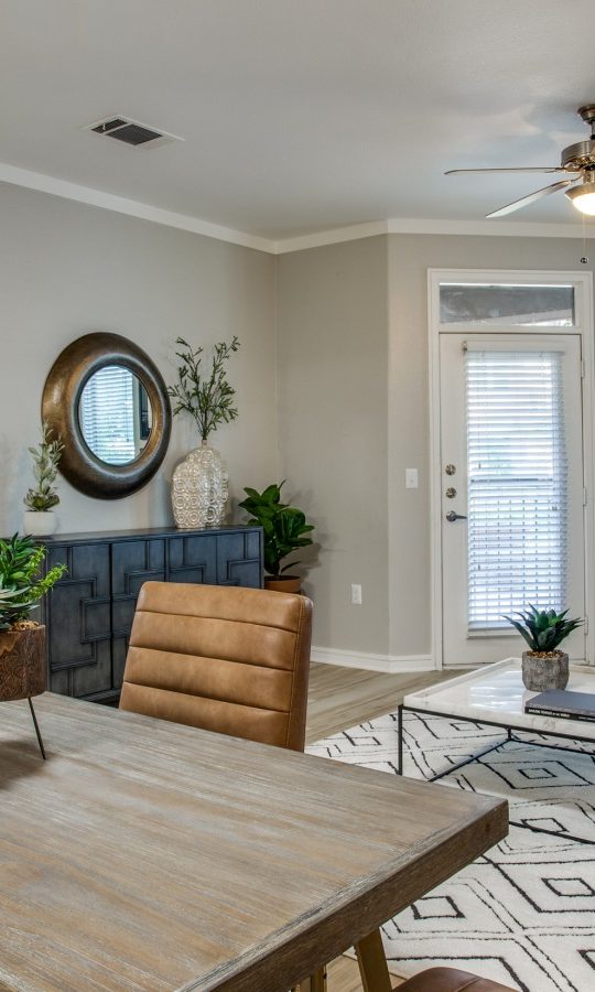 a living room with a dining table and chairs at The  Franklin at Samuels Ave
