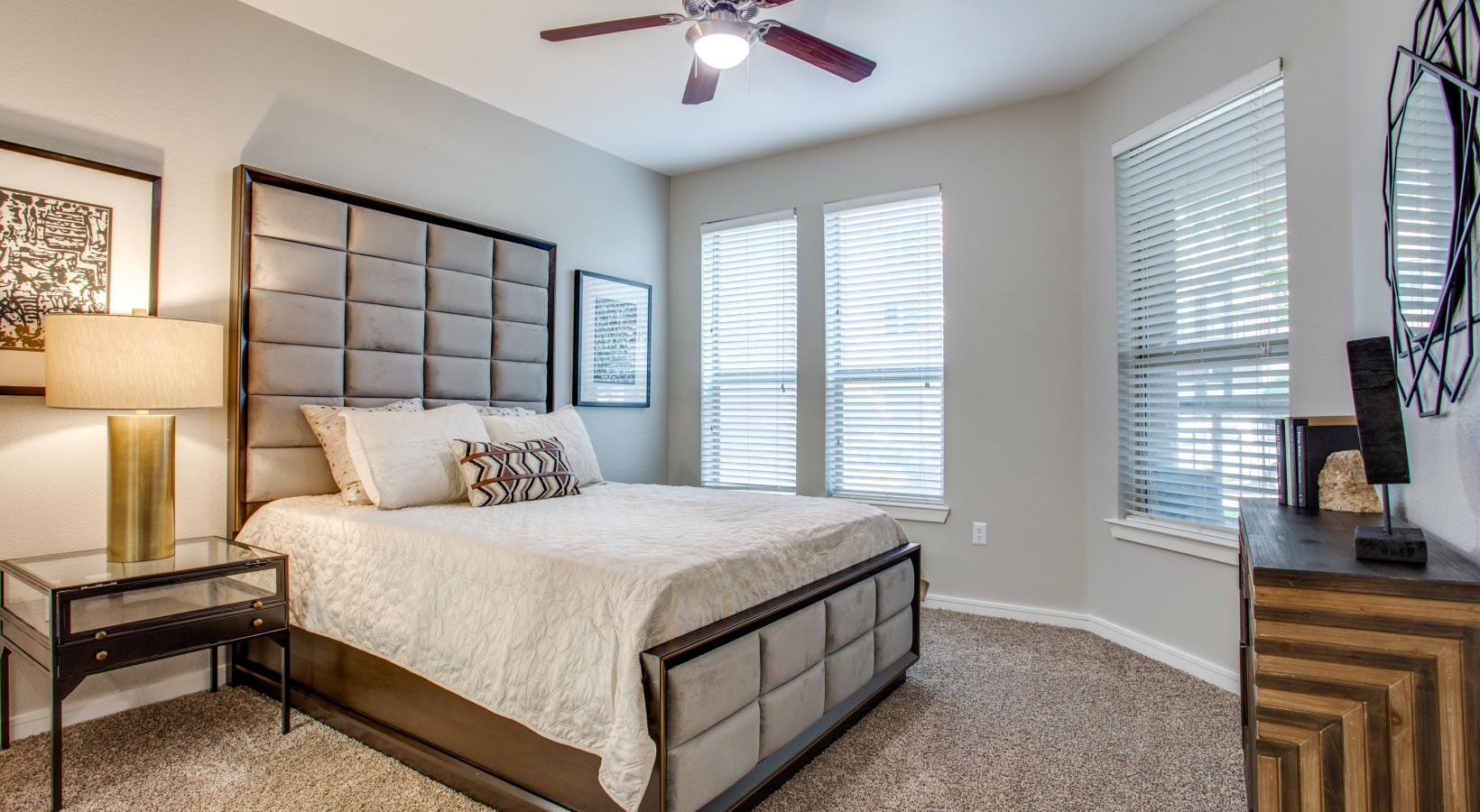 a bedroom with a large bed and ceiling fan at The  Franklin at Samuels Ave