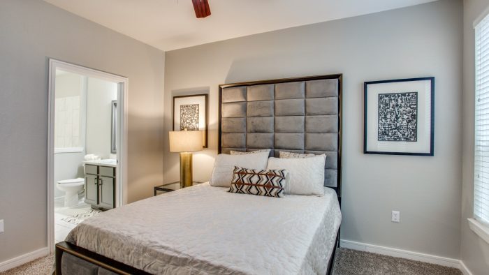 a bedroom with a large bed and a ceiling fan at The  Franklin at Samuels Ave