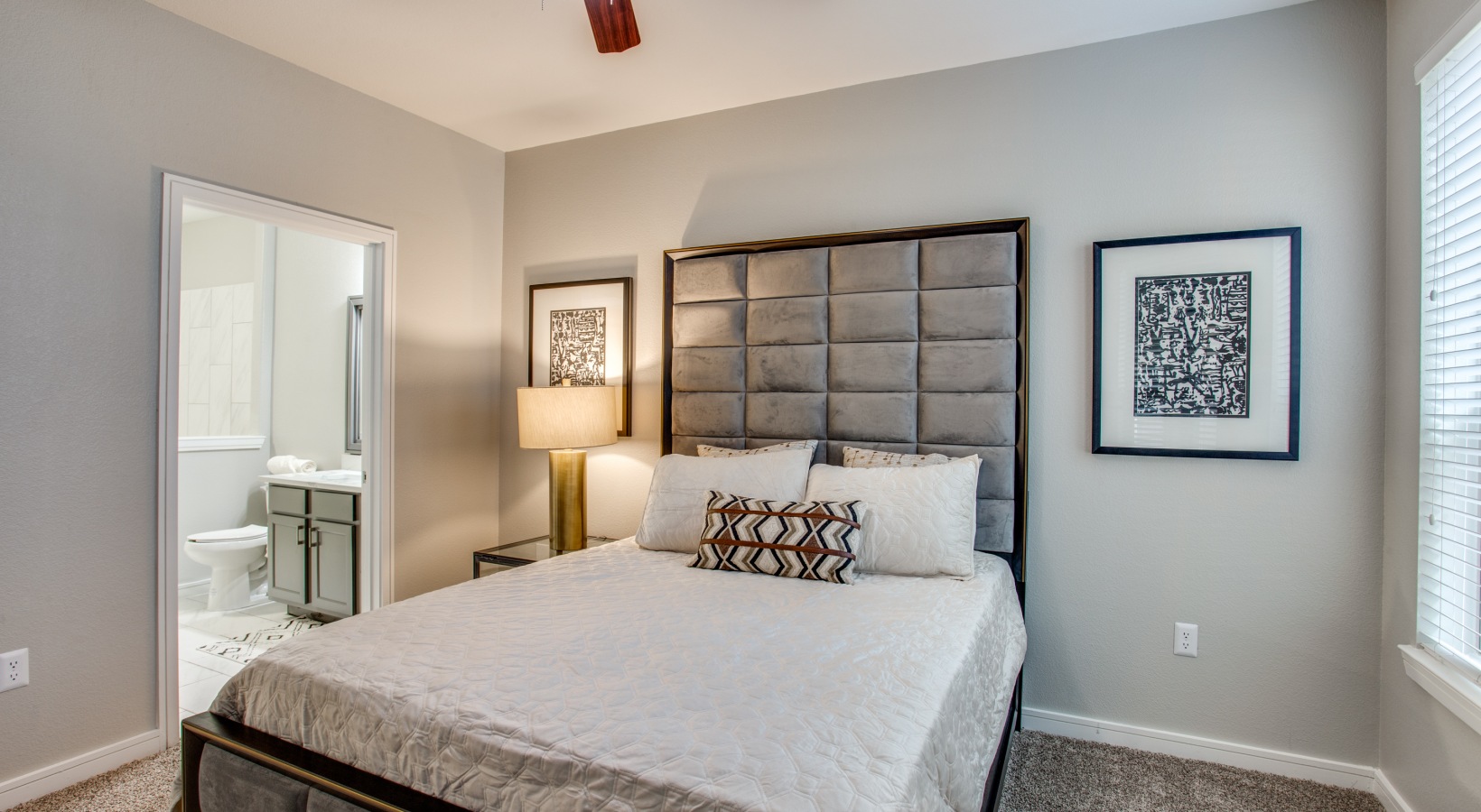 a bedroom with a large bed and a ceiling fan at The  Franklin at Samuels Ave