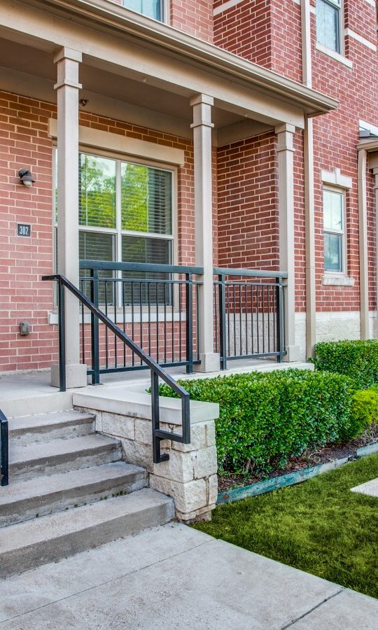 a brick walkway with steps leading to a front door at The  Franklin at Samuels Ave