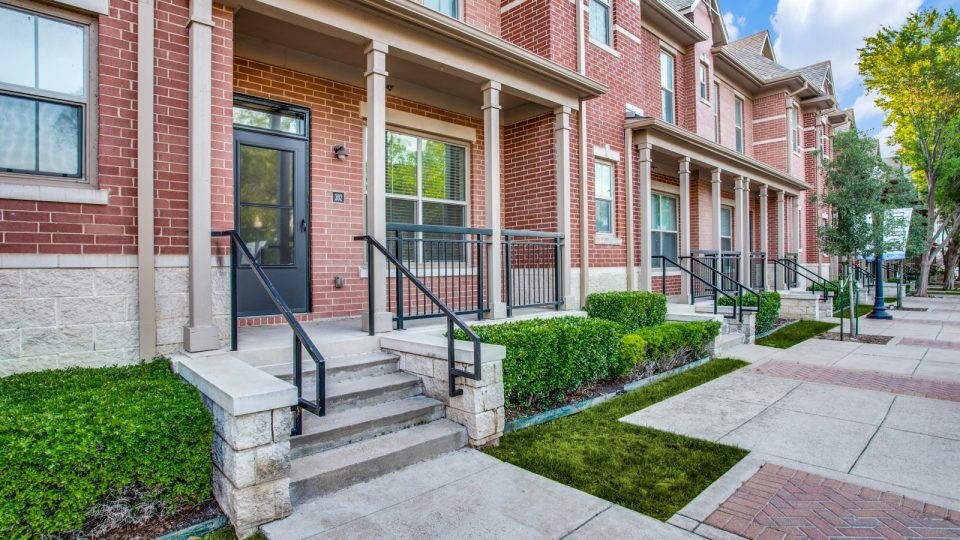 a brick walkway with steps leading to a front door at The  Franklin at Samuels Ave